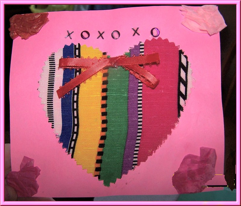 An image of a handmade card with a multicolored heart on it